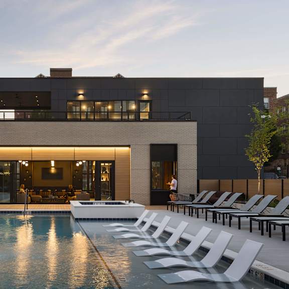 a modern house with a pool in front.