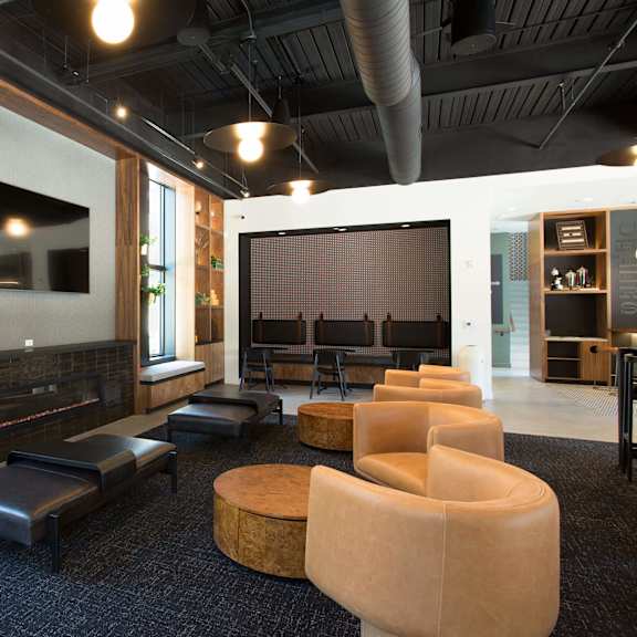 a modern living room with a fireplace and a large screen tv.