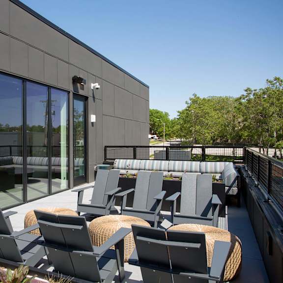 a modern patio with grey chairs and tables.