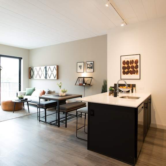 a modern kitchen with a dining table and chairs.