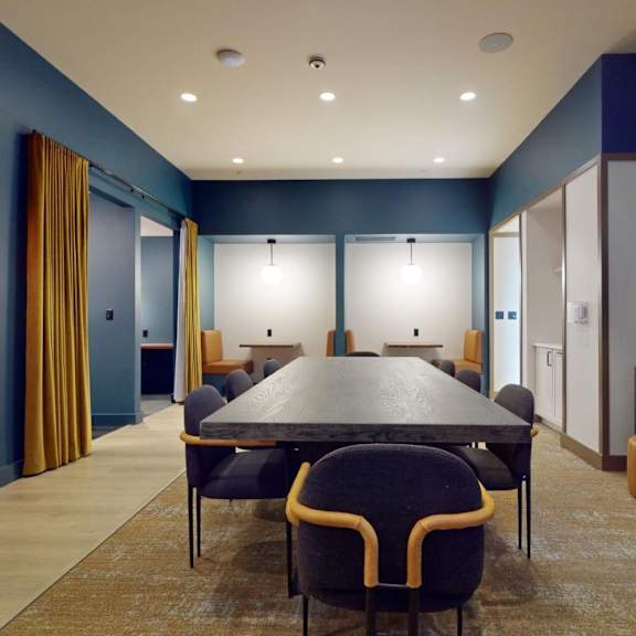 a conference room with a long table and chairs.