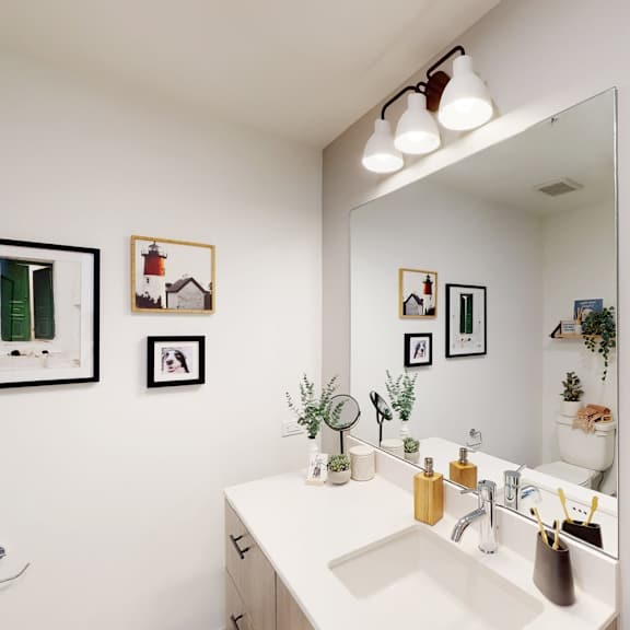 a bathroom with a white sink and a mirror above it.