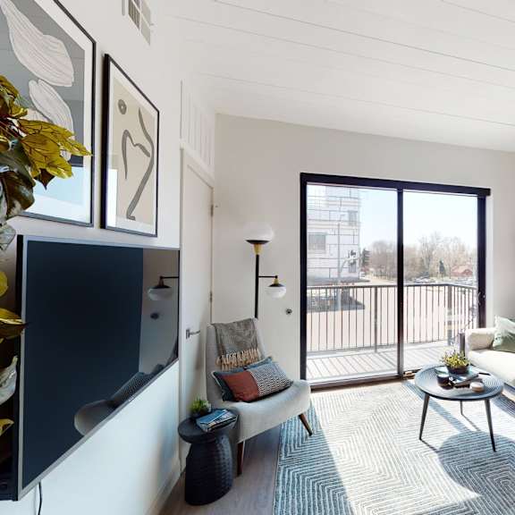a living room with a couch, a coffee table, and a large window.