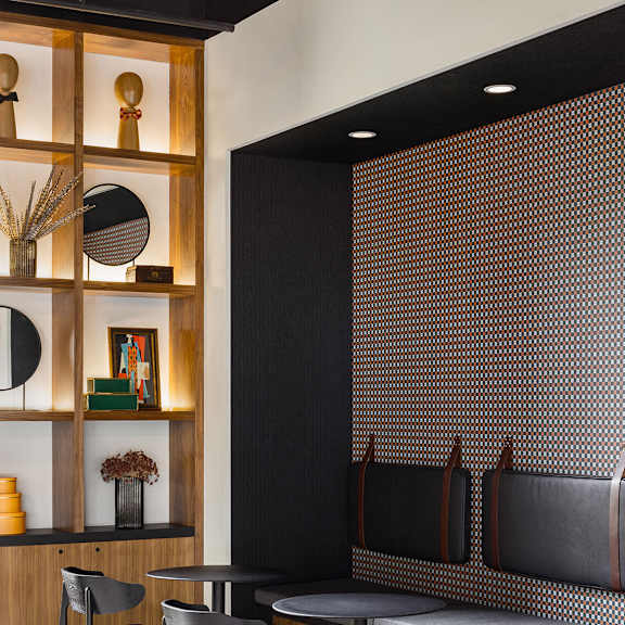 a black and white dining room with a wooden shelf and chairs.