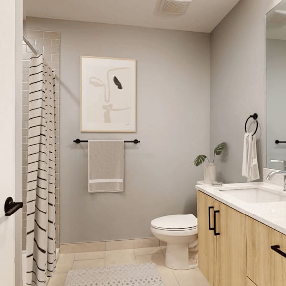 a bathroom with a toilet, sink, and a mirror.