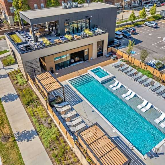 a modern building with a pool in the foreground.