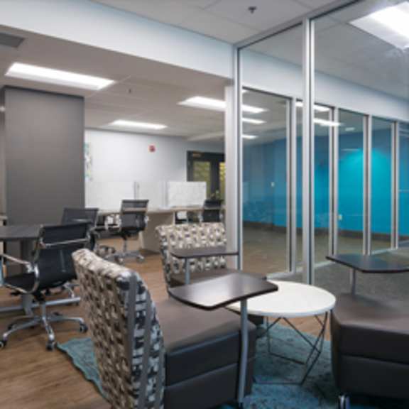 a conference room with a white table and chairs.