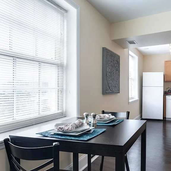 a kitchen with a dining table and chairs is shown.