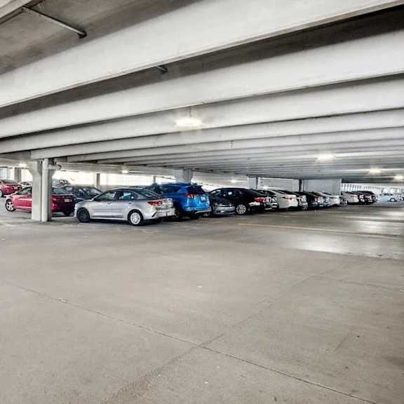 a parking garage with cars parked in it.