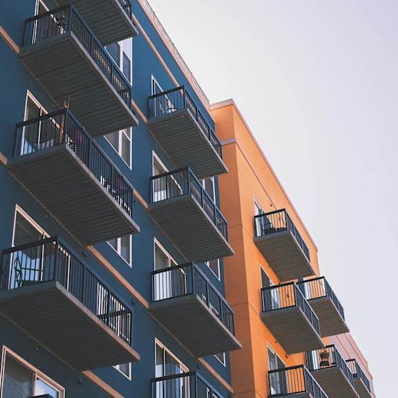 a tall building with balconies and windows.