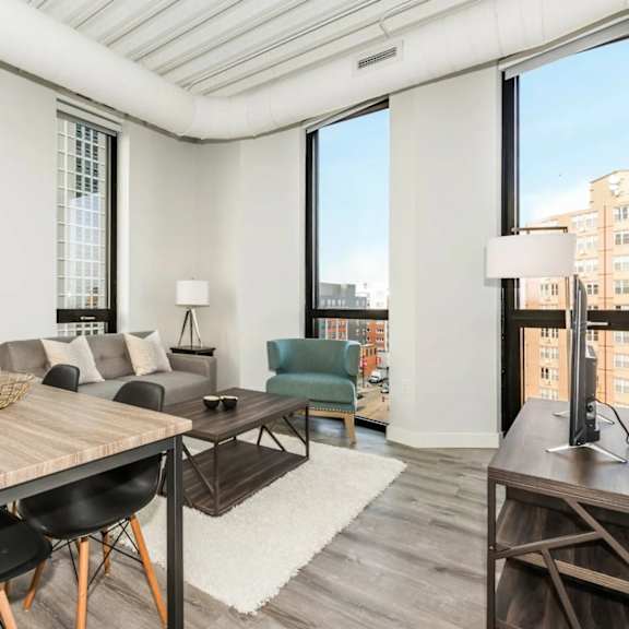 a modern dining room with a wooden table and chairs.