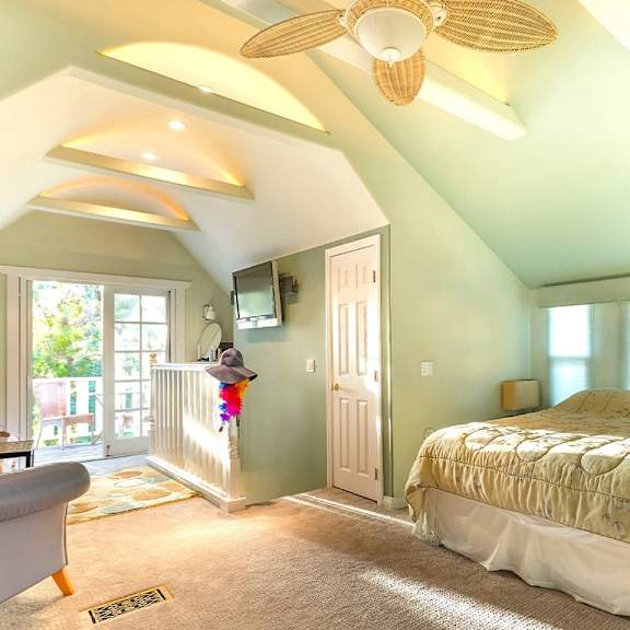 a bedroom with a bed, chair, and window.