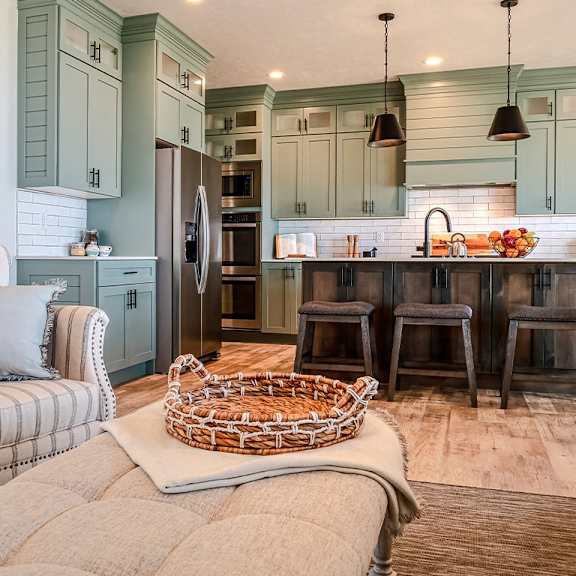 a kitchen with a striped chair and a basket on the floor.