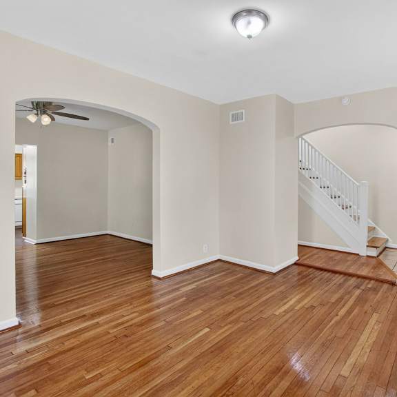 a room with wooden floors and a staircase.
