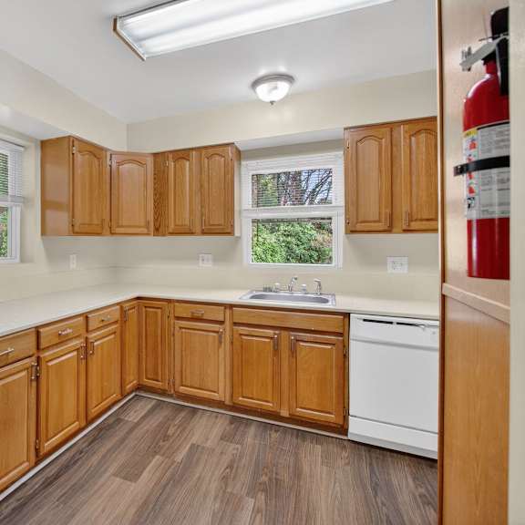 a kitchen with wooden cabinets and a white stove.