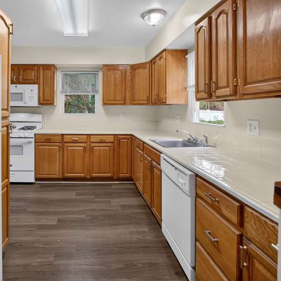 a kitchen with wooden cabinets and a white refrigerator.