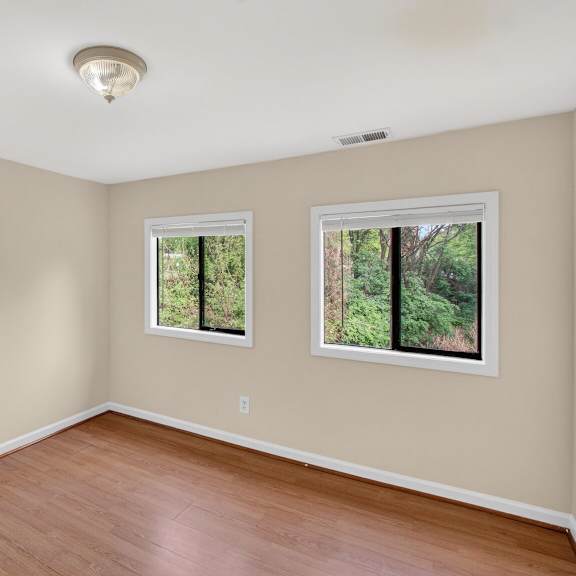 a room with a window and a wooden floor.