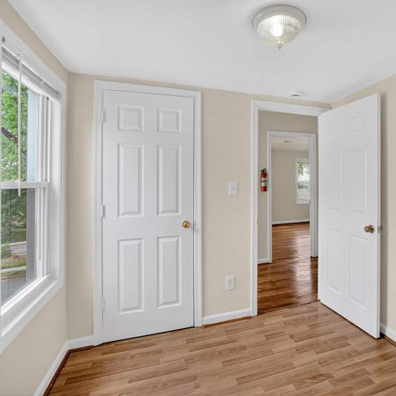 a room with a white door and a window.