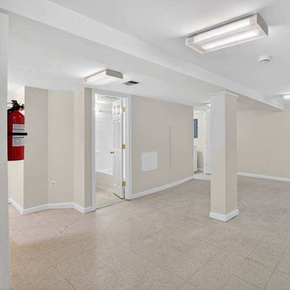 a room with a fire extinguisher on the left side.