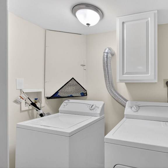a washing machine and dryer in a small laundry room.