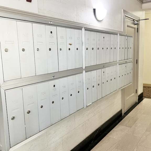 a row of white metal lockers with numbers on them.