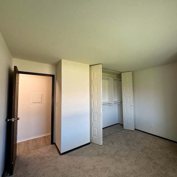 a room with a carpeted floor and white walls.