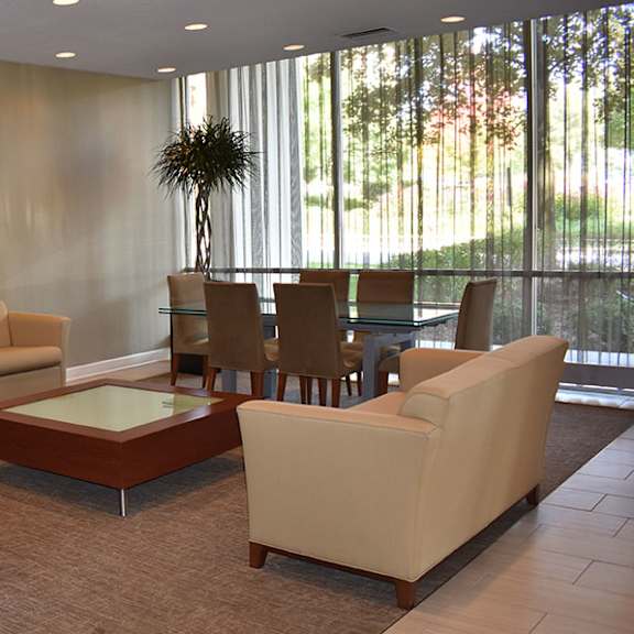 a living room with a couch, chairs, and a table.
