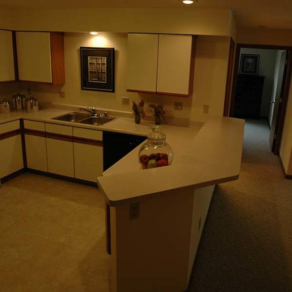 a kitchen with a table and chairs in the middle of the room.