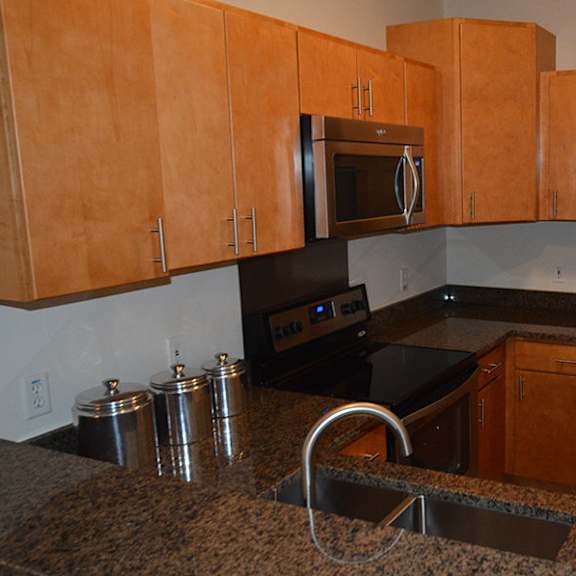 a kitchen with a granite counter top and stainless steel appliances.