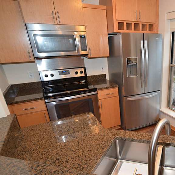 a kitchen with granite countertops and stainless steel appliances.