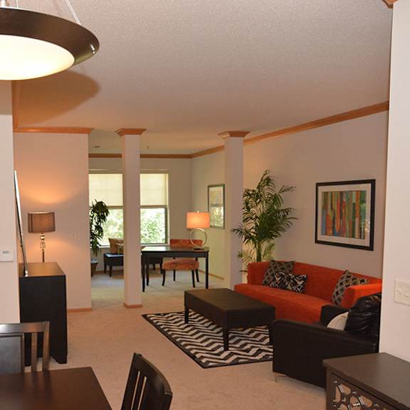 a living room with a couch, chairs, and a table.