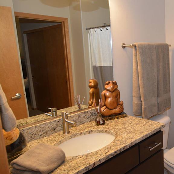 a bathroom with a toilet, sink, and shower curtain.