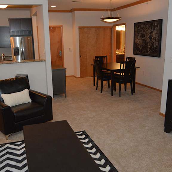 a living room with a black and white striped rug.