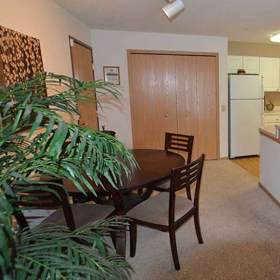 a kitchen with a table and chairs in the middle of the room.
