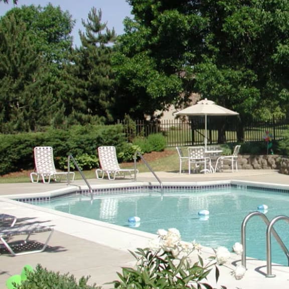 a pool with a gazebo in the background.