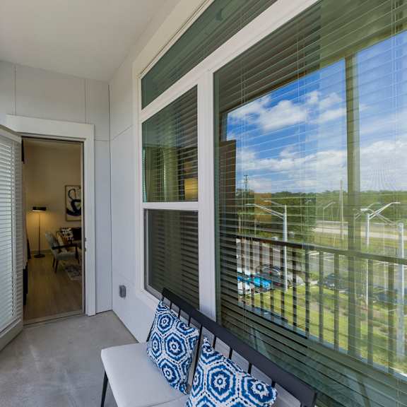 Thumbnail 9 of 9 Screened balcony with seating and glass windows at Ciel Luxury Apartments, Jacksonville, Florida