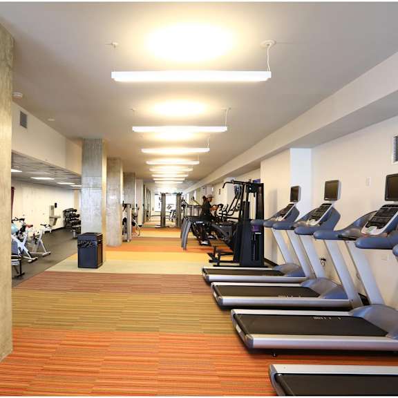 a gym with treadmills and exercise equipment.