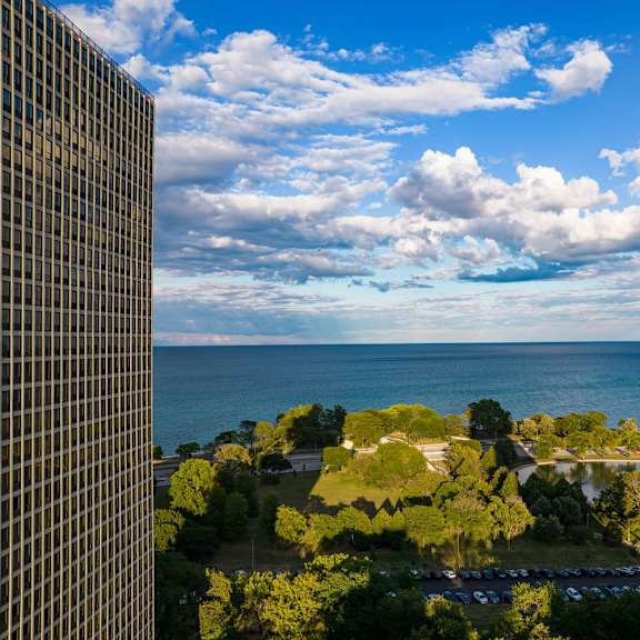 a view from a high-rise building looking out over a coastal landscape.