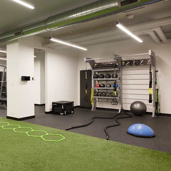 a gym with a green floor and white walls.