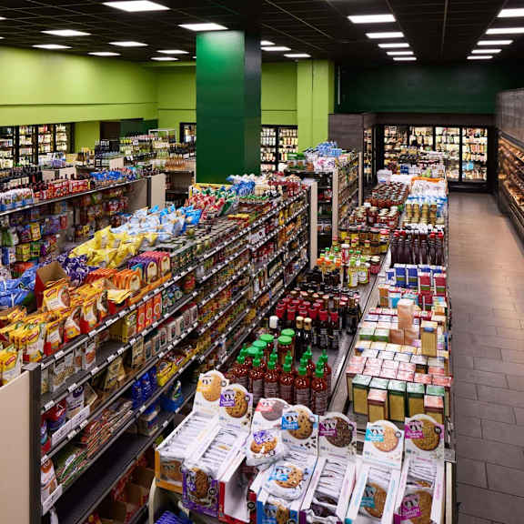 a supermarket aisle with a variety of snacks and drinks.