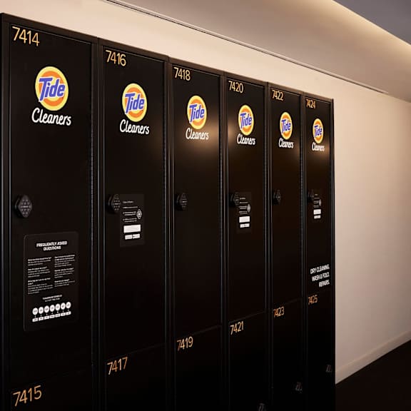 a row of tide cleaners are lined up against a wall.