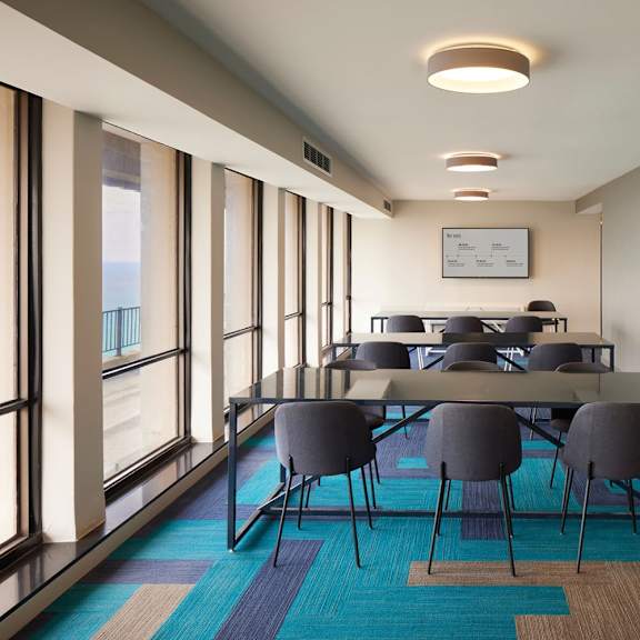 a conference room with a long table and chairs.