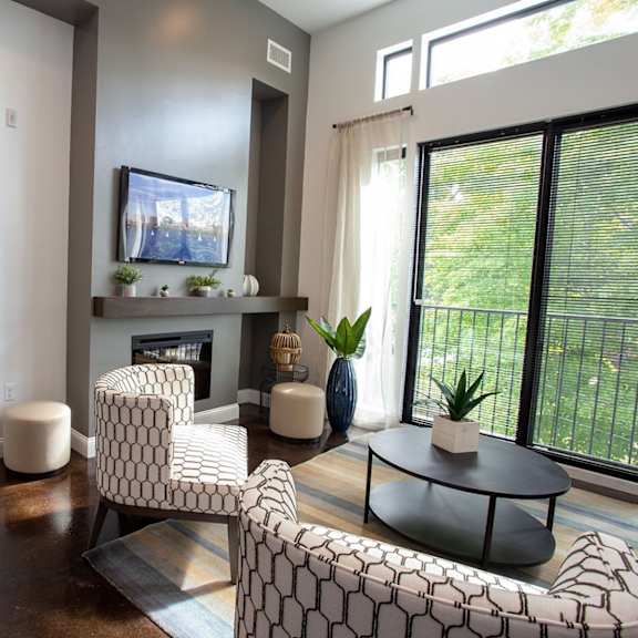 a living room with a fireplace and a television.