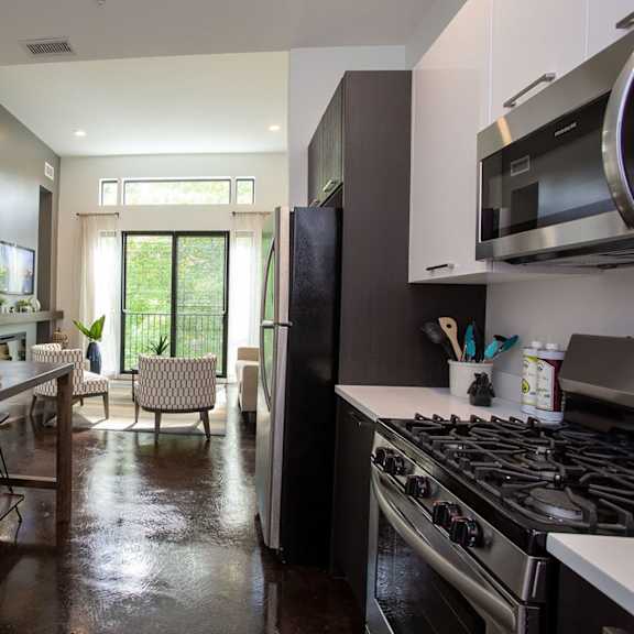 a kitchen with a stove top oven and a refrigerator.