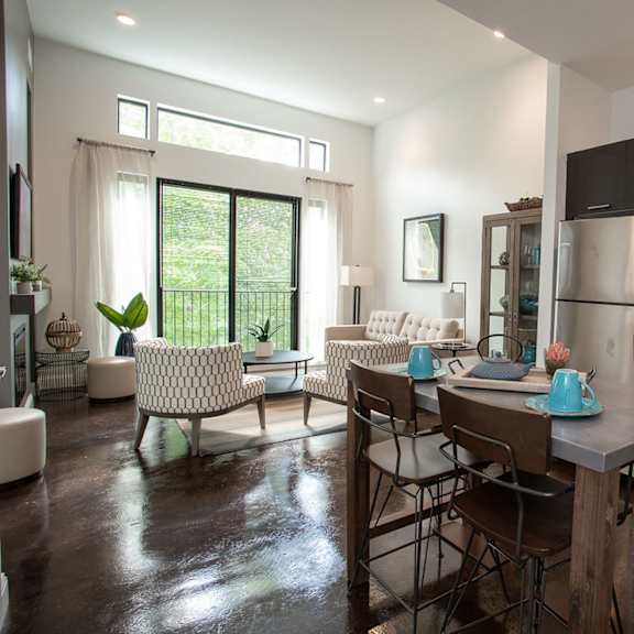 a modern kitchen with a dining table and chairs.