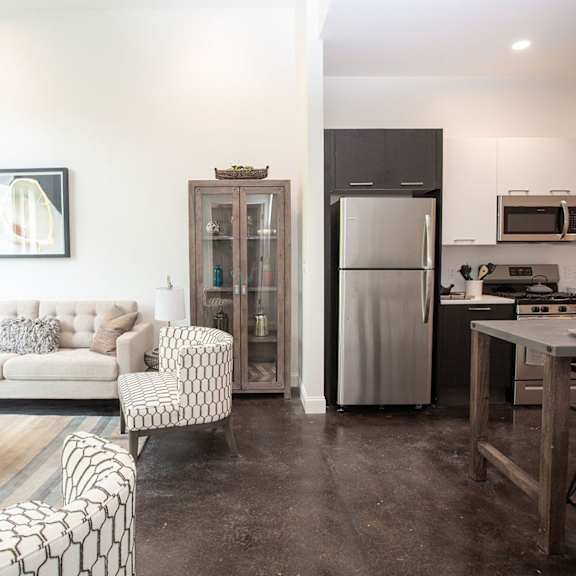 a modern kitchen with a refrigerator, microwave, and oven.