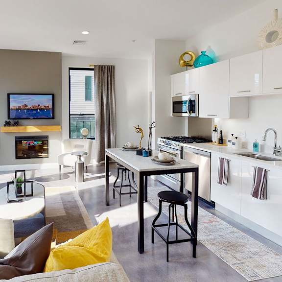 a modern living room with a grey sofa and a television.