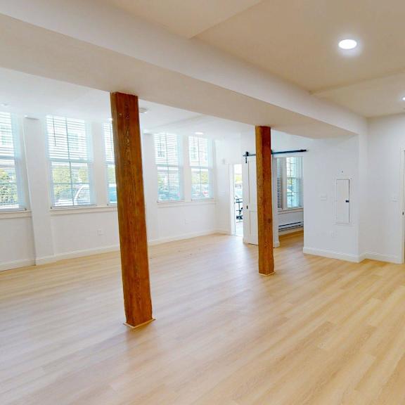 a room with wooden floors and white walls.