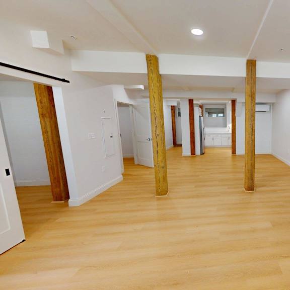 a room with a fireplace and wooden floors.