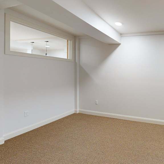 a room with a carpeted floor and a door.